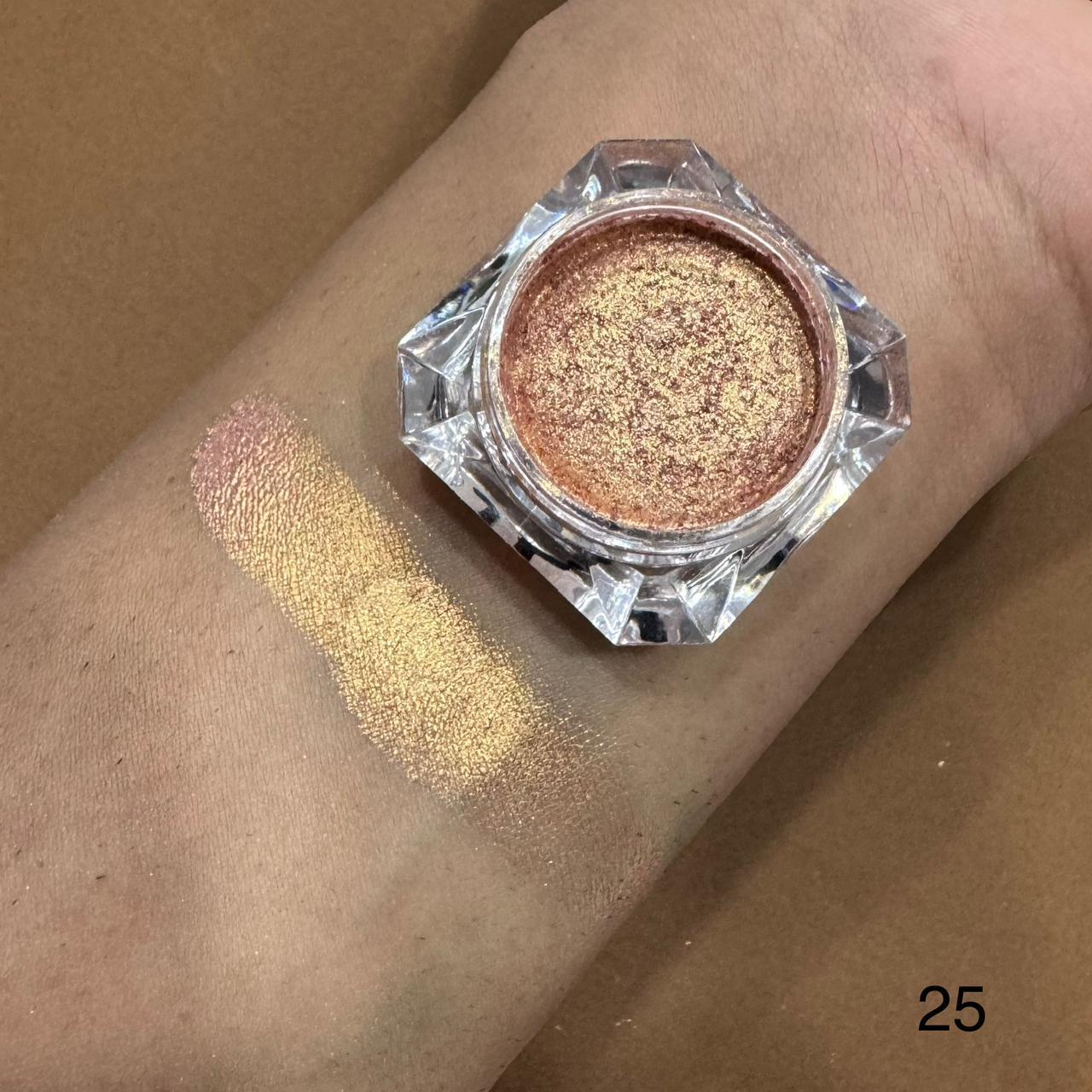 Gold glittery makeup product on a wrist with swatch