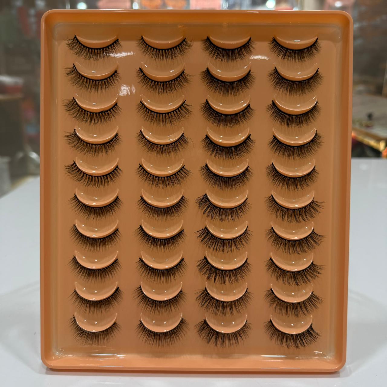 Set of 20_Pairs_Party_Lashes on an orange tray with a blurred background
