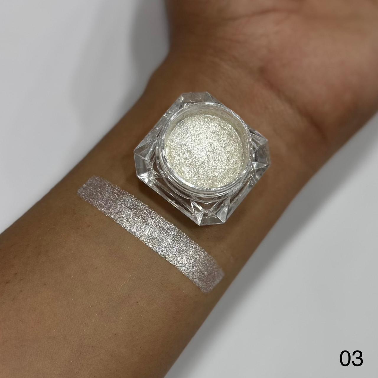 Silver glitter on a wrist with a jar of glitter above it, on a white background.