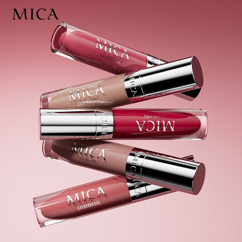 Five MICA cosmetic lipsticks in various shades on a pink background