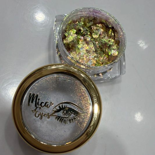Mica Eyes glitter container with lid on a reflective surface