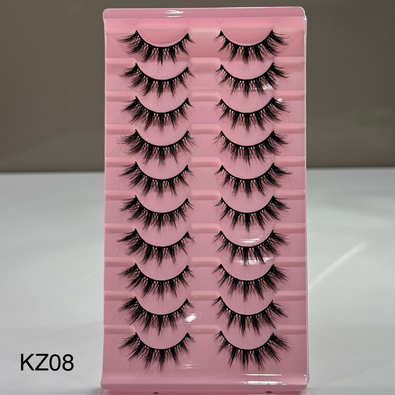 Pink tray with false eyelashes labeled KZ08 on a white background
